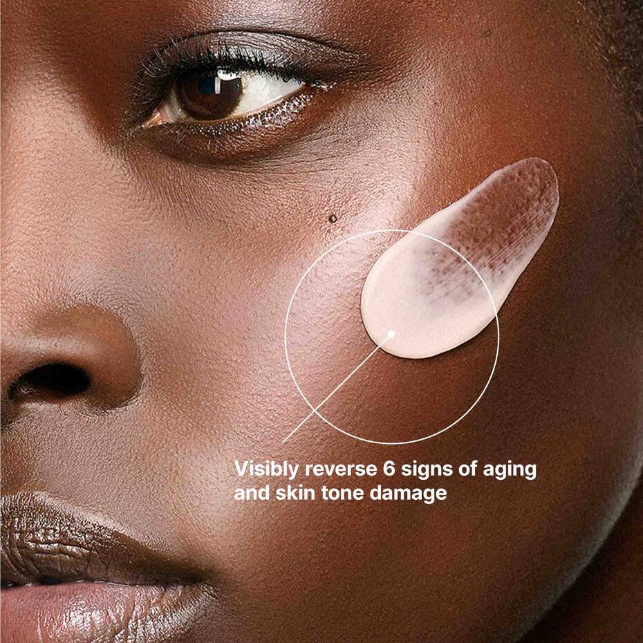 Close-up of a person's face with text claiming to reverse aging signs and skin tone damage.
