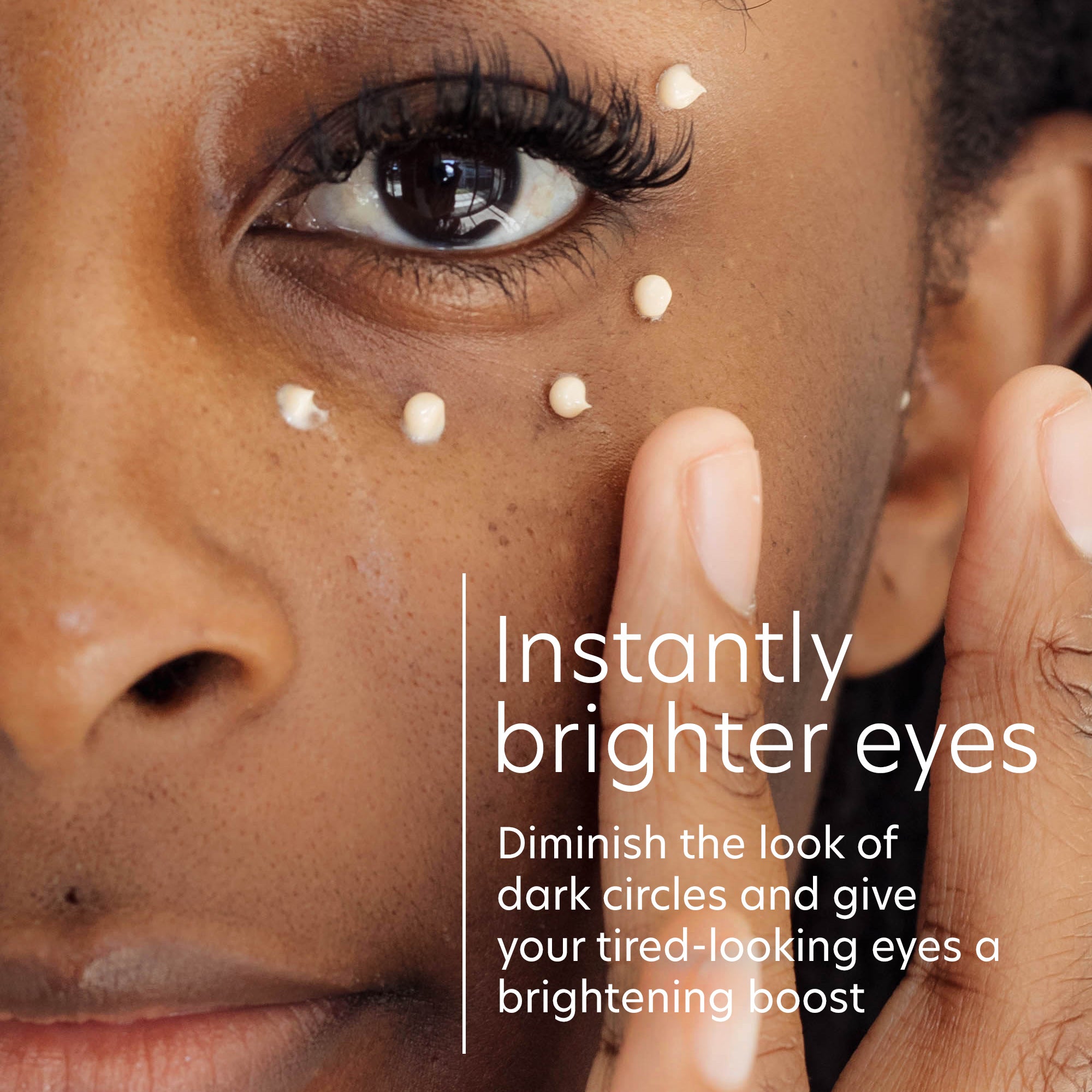 Close-up of a person's eye with dark circles and text promoting a product for brightening eyes.