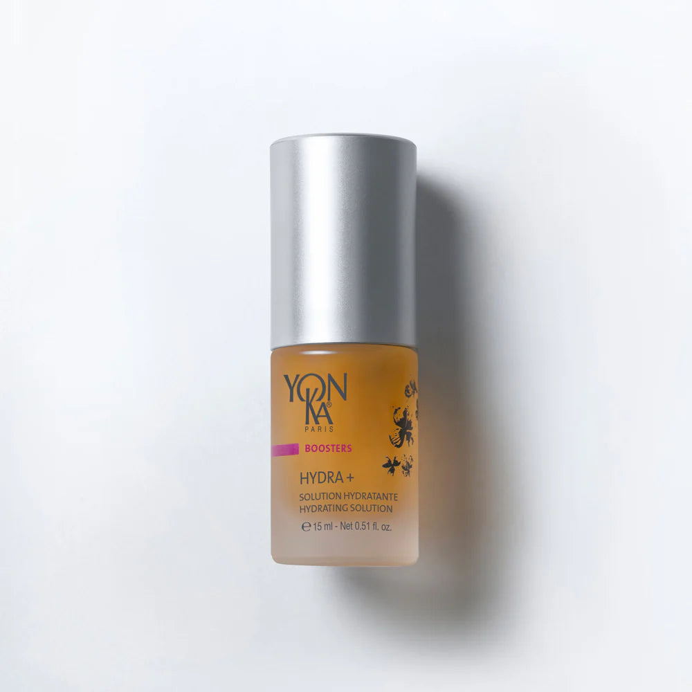 Skincare bottle with silver cap and orange body on a white background