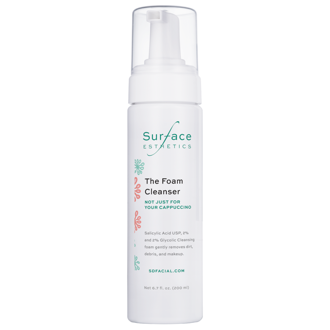 Foam cleanser bottle with 'Surface Esthetics' branding on a white background