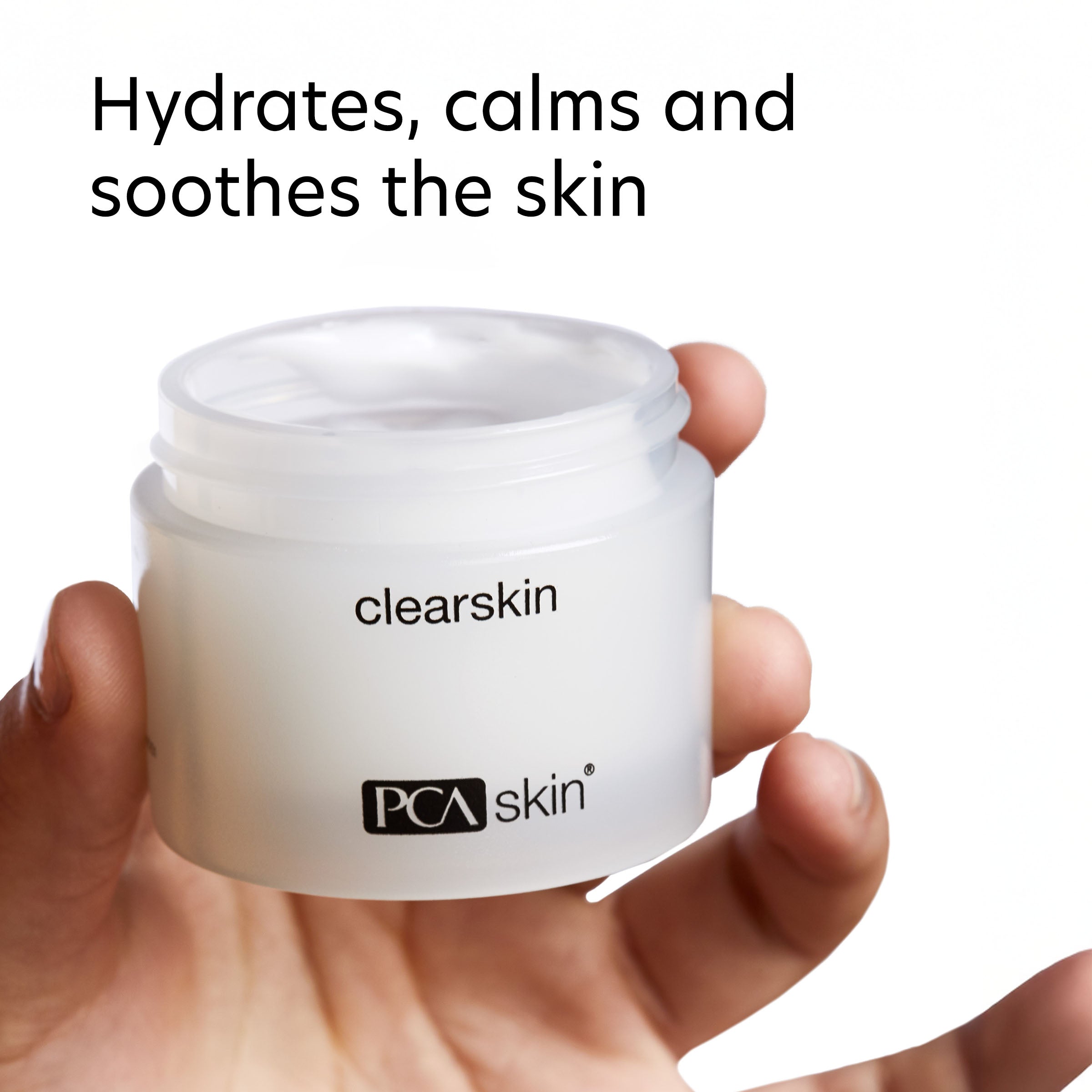 Jar of PCA Skin clearskin cream held by a hand with text indicating benefits.