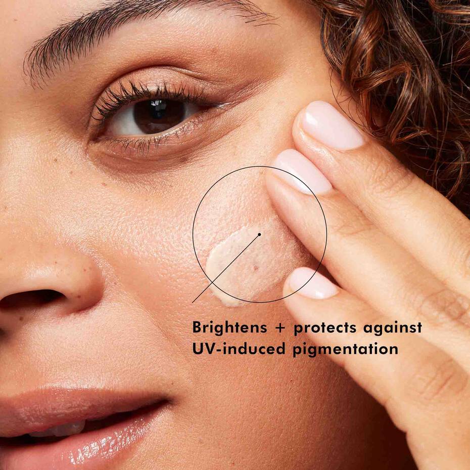 Close-up of a person applying a skincare product to their face with text about UV protection.