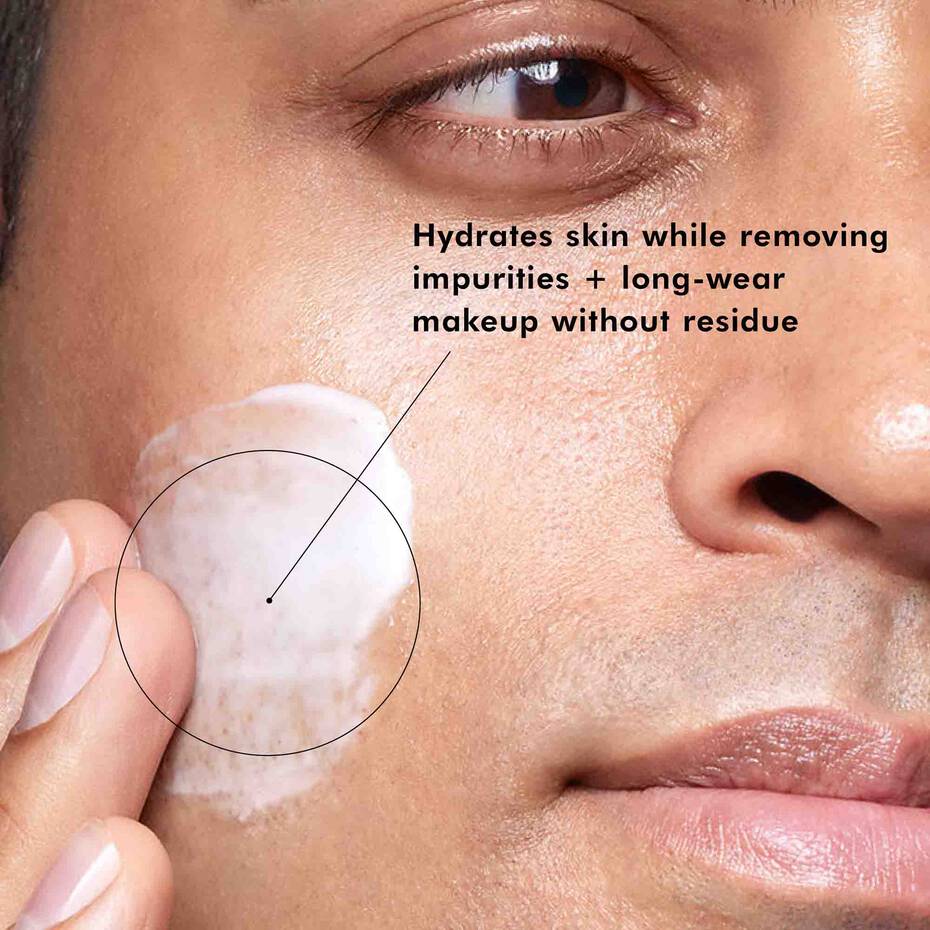 Person applying a skincare product to their face with text highlighting product benefits.