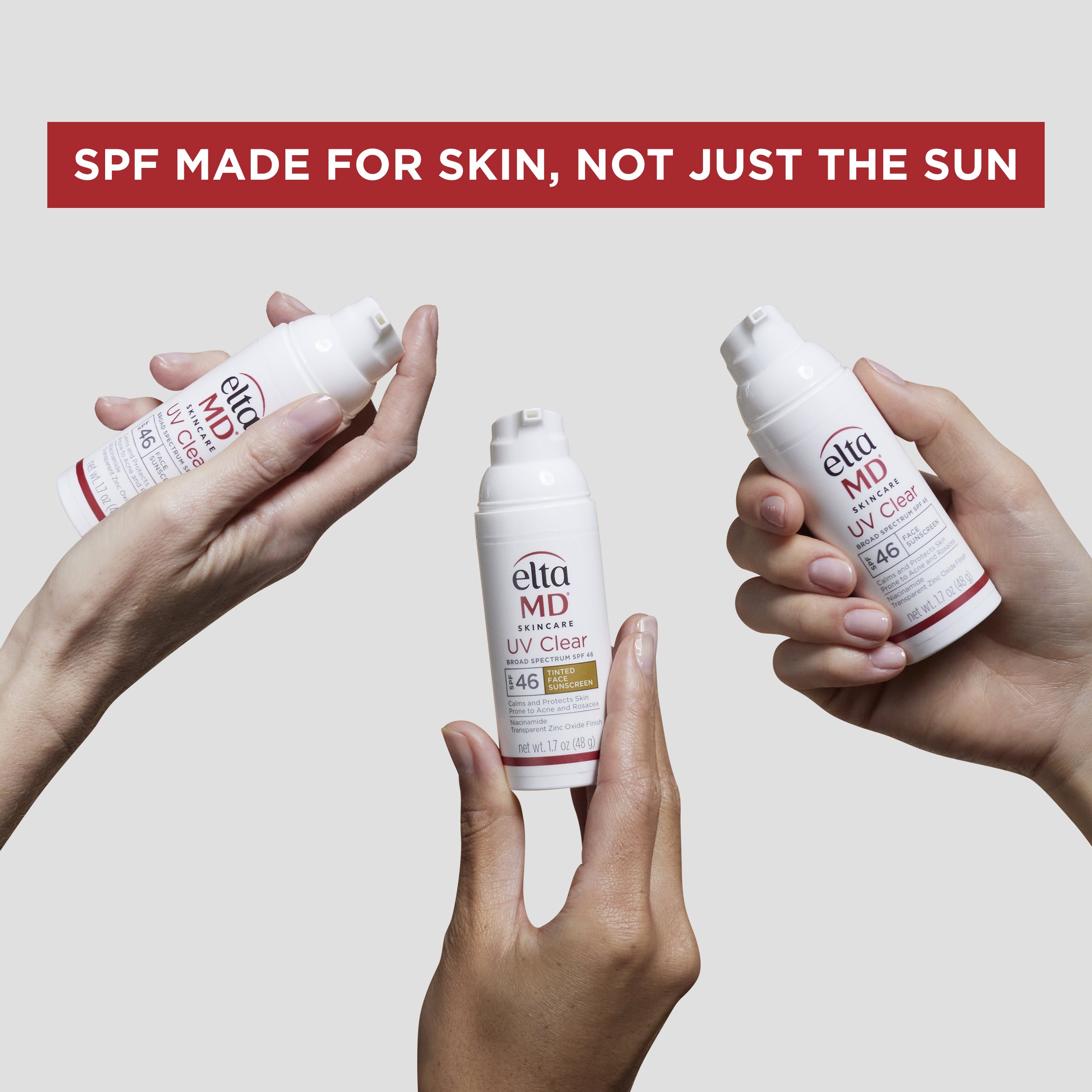 Three bottles of elta MD UV Clear sunscreen held by hands against a light gray background.