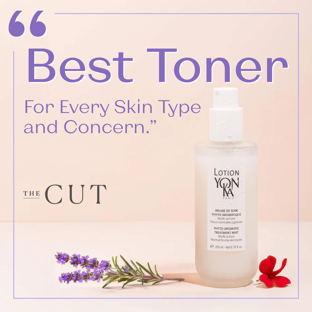 Lotion bottle with lavender and red flower on a light pink background, labeled 'The Cut'.